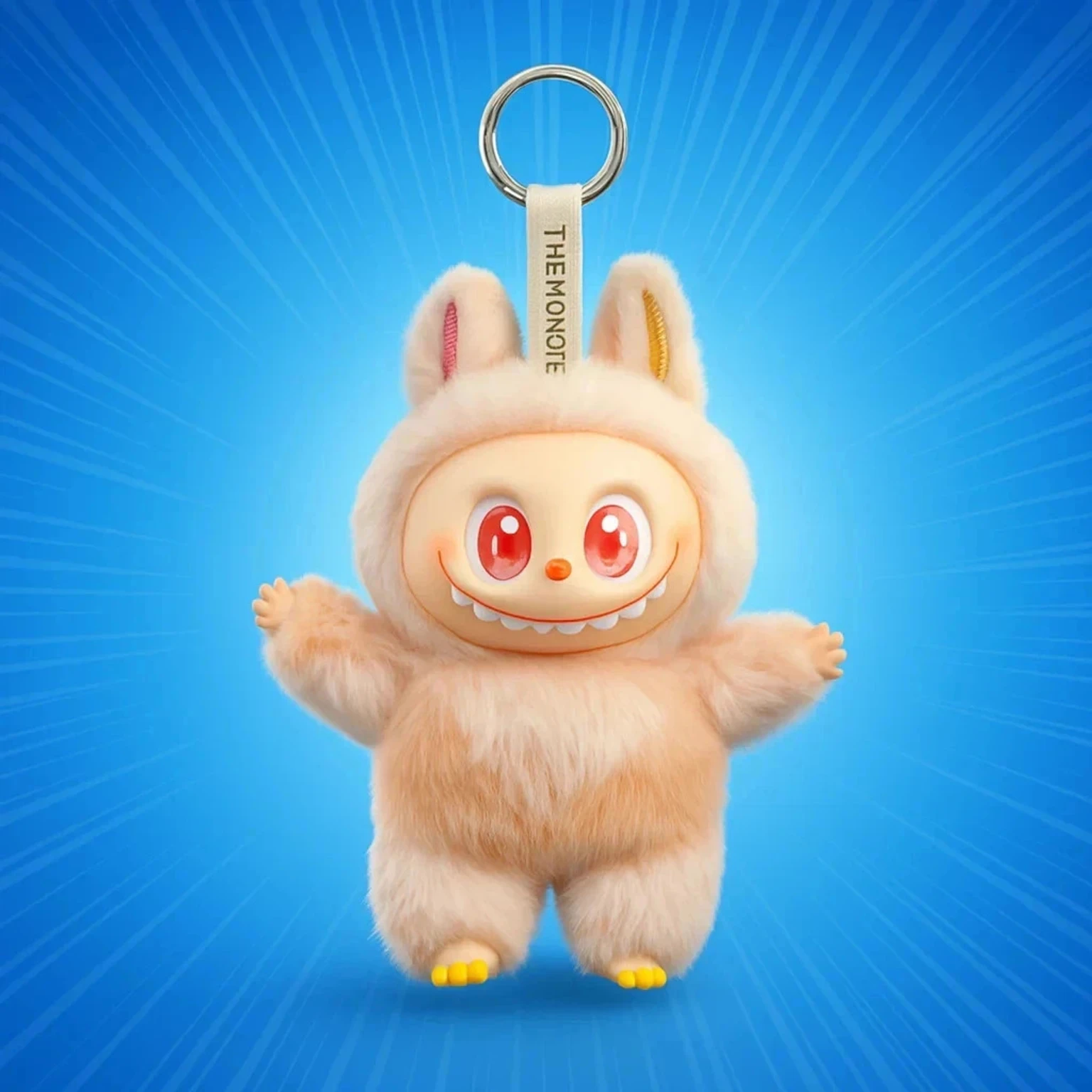 A beige, plush Labubu Monster collectible figure keychain featuring long serrated teeth, large red eyes, pointed ears, and a silver metal ring attachment against a radiating blue background.
